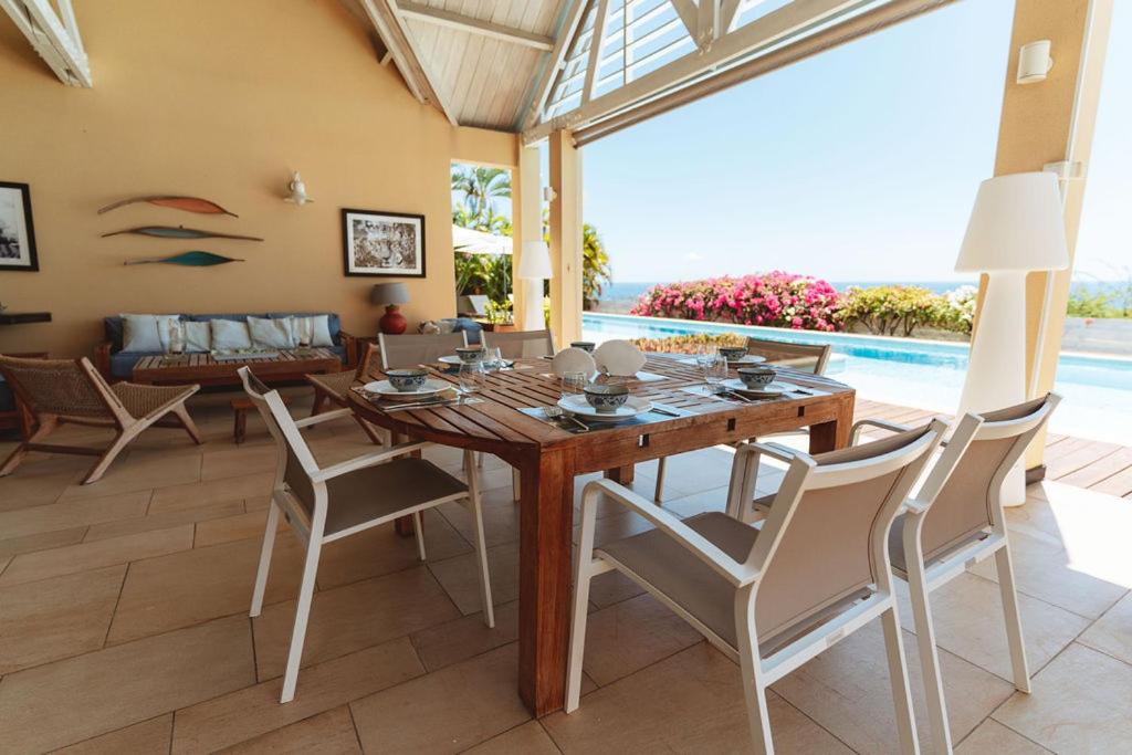 Table dressée sur la terrasse couverte au bord de la piscine